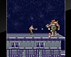 《Contra》游戏截屏，展示了一名士兵在建筑物屋顶与一个巨大人形外星人作战。