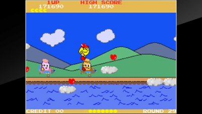 《Pac-Land》游戏截屏，展示了主角Pac-Man正在穿越一片翠绿的地带。
