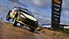 EA Sports WRC screenshot showing a car leaving the ground while racing