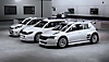 EA Sports WRC screenshot showing three white vehicles in a garage setting