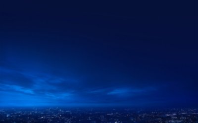 Background artwork of a night sky with the night lights of a city below