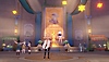 Captura de tela de Genshin Impact 4.3 mostrando um grupo de personagens ao redor de uma luz dourada em um ambiente amplo