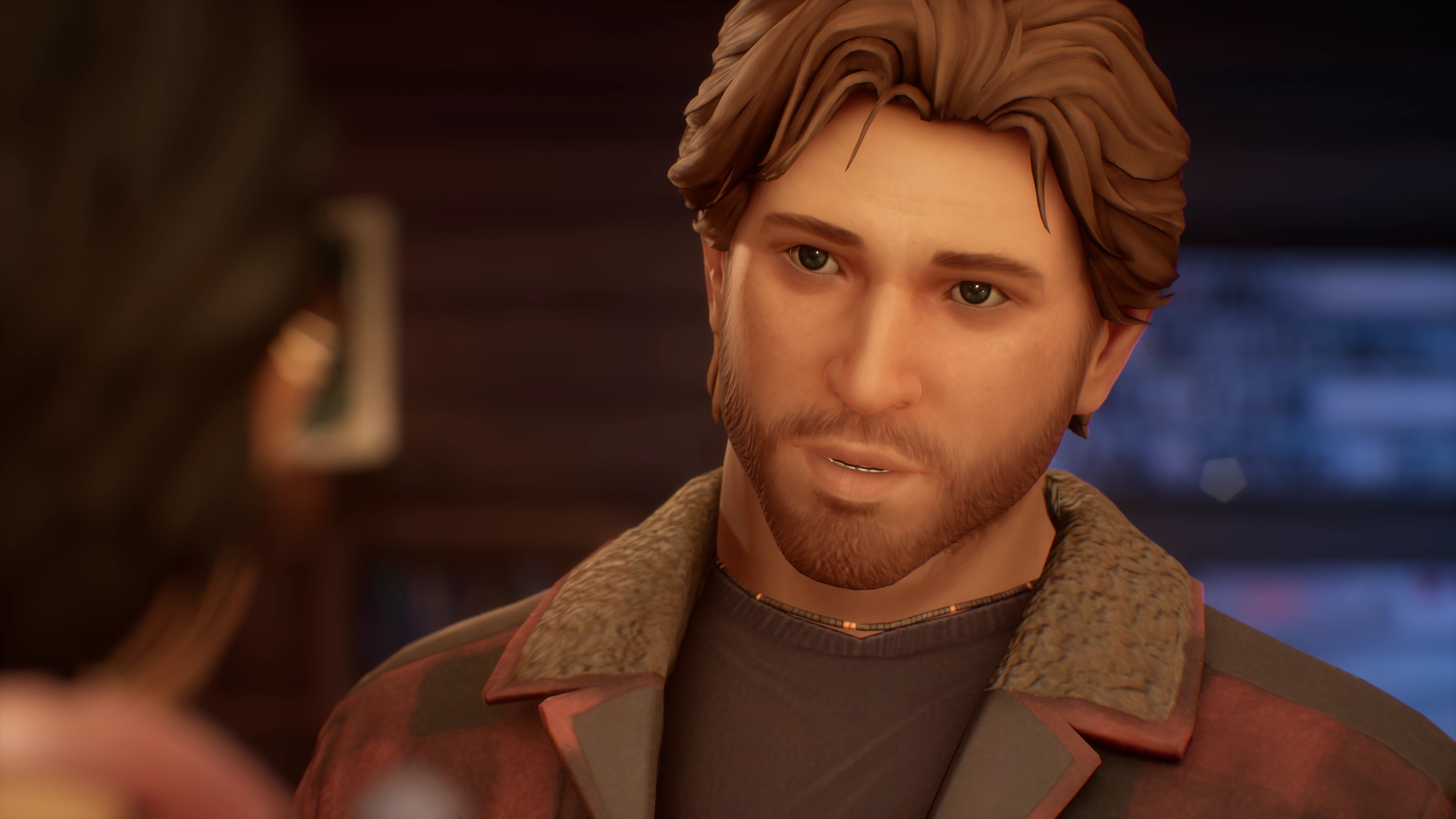 Life Is Strange: True Colors – Screenshot, der Alex im Gespräch mit einem anderen Charakter zeigt.