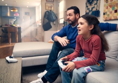 A father and daughter play together.