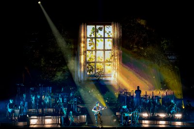 A single beam of light. A guitar. A world remembered in sound and silence.