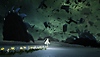 Captura de tela de After Us mostrando Gaia percorrendo uma paisagem desolada, com flores crescendo por onde ela passa