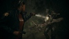 Alan Wake 2 screenshot showing Saga Anderson shining a torch on a monstrous enemy holding a large tree branch
