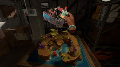 Another Fisherman's Tale screenshot showing a tabletop island and a hand holding a model boat
