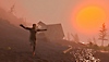 Zrzut ekranu z gry Baby Steps przestawiający niezdarnego głównego bohatera, który rozciąga ramiona i próbuje przejść wzdłuż zbocza góry o wschodzie słońca