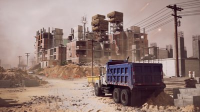 A dusty construction site with unfinished buildings.