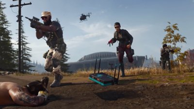 Call of Duty Warzone screenshot showing three Operators mid-run, with a wifi router visible in the foreground.