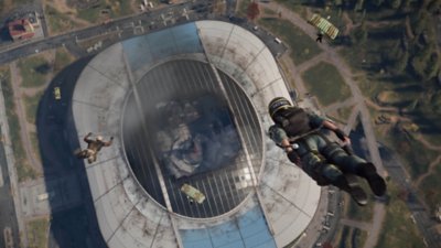 Call of Duty Warzone screenshot showing two Operators skydiving into the open roof of Verdansk stadium