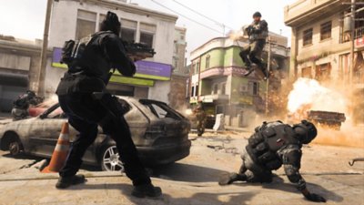 Call of Duty: Modern Warfare II screenshot showing five operators in an explosive gun battle, with one of them leaping in the air and shooting