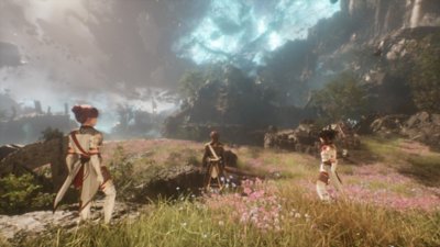 Gameplay screenshot from Clair Obscur: Expedition 33 depicting three characters crossing a flower-covered landscape.