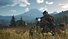 Days Gone screenshot featuring main protagonist Deacon St. John riding a motorcycle through a grassy wilderness.
