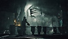 צילום מסך של Dead Space המציג את אייזק מביט לאורכו של חדר גדול מלא מכונות