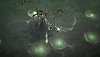 Diablo IV ekran görüntüsü, tam bir Karga zırh setinin içindeki erkek ve kadın büyücüleri gösteriyor 