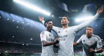 EA Sports FC 25 screenshot showing Jude Bellingham celebrating with Real Madrid teammates Vinícius Júnior and Kylian Mbappé