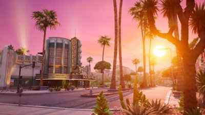 Fortnite Chapter 7 Season 1 screenshot showing the road outside of a cinema while the sun sets