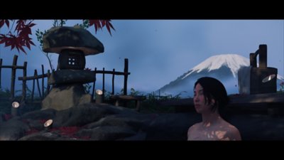 Gameplay screenshot from Ghost of Yōtei depicting Atsu in a hot spring.
