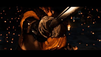 Cinematic screenshot from Ghost of Yōtei depicting Atsu holding a katana outstretch, the tsuba in clear focus.