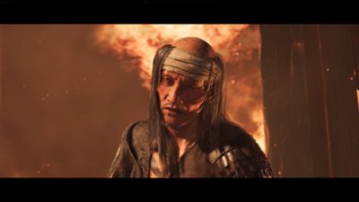 Gameplay screenshot from Ghost of Yōtei depicting The Snake emerging from a burning building.
