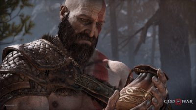 god of war pc screenshot showing Kratos holding a small sack