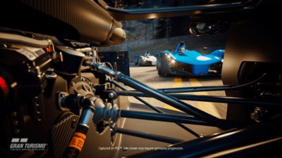Gran Turismo 7 announcement screenshot showing racing action from the view of a car's suspension