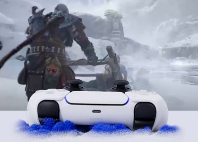 Kratos riding a sled pulled by dogs, in front of a DualSense controller