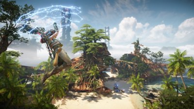 Horizon Forbidden West screenshot depicting Aloy flying over an overgrown beach on a hand glider.