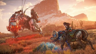 Horizon Zero Dawn Remastered screenshot showing Aloy riding a Charger machine towards a Thunderjaw