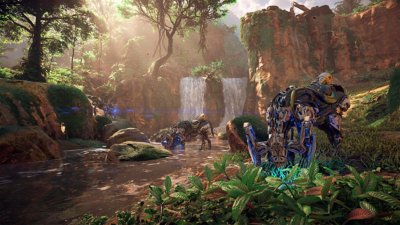 Horizon Zero Dawn Remastered screenshot showing some machines grazing in front of a pair of waterfalls