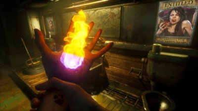 Judas screenshot showing the game's first-person view. The character is gripping their left wrist as a ball of fire emerges from the palm of their hand.