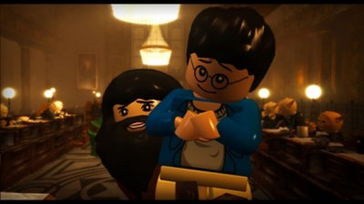 LEGO Harry Potter screenshot showing Harry being lifted by Hagrid