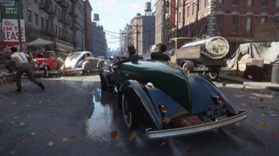Gameplay screenshot from Mafia: Definitive Edition depicting a car chase through a busy city street.