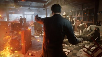 Gameplay screenshot from Mafia: Definitive Edition depicting a firefight in a burning building.