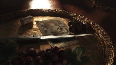 Mafia: The Old Country screenshot showing a knife on a tray beside grapes and a wine bottle cork