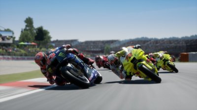 MotoGP 24 screenshot showing four racers leaning into a corner