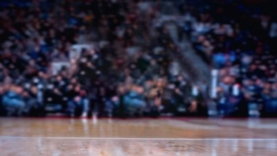 NBA 2K26 background showing a blurred crowd and basketball court