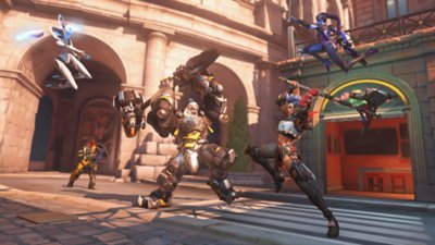 Overwatch 2 screenshot of characters swinging axe and giant hammer at one another.