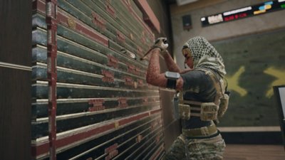 Tom Clancy's Rainbow Six Siege screenshot showing a player breaking the lock on a garage door