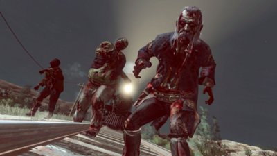 Captura de pantalla de Red Dead Redemption que muestra zombis caminando por una vía de tren