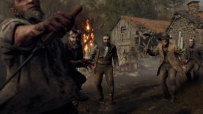 Captura de pantalla de Resident Evil 4 que muestra a una multitud de aldeanos asesinos.