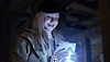Resident Evil Village Shadows of Rose DLC screenshot showing Rose Winters holding a glowing object