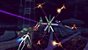 Rez Infinite – zrzut ekranu przedstawiający postać gracza walczącą z wrogiem podobnym do satelity i kilkoma dronami w 2. obszarze