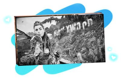 Horizon Forbidden West screenshot showing Aloy blowing a kiss to the camera in front of the Hollywood sign