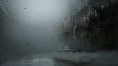 Captura de pantalla de Silent Hill 2 que muestra una calle desierta y llena de niebla