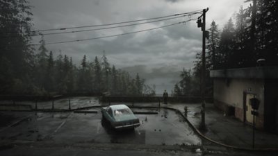 Silent Hill 2 ภาพหน้าจอแสดงให้เห็น James มองไปที่ทิวทัศน์แสนสงบที่เต็มไปด้วยต้นไม้