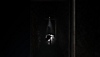 Silent Hill: The Short Message screenshot showing a creepy figure at the end of a corridor