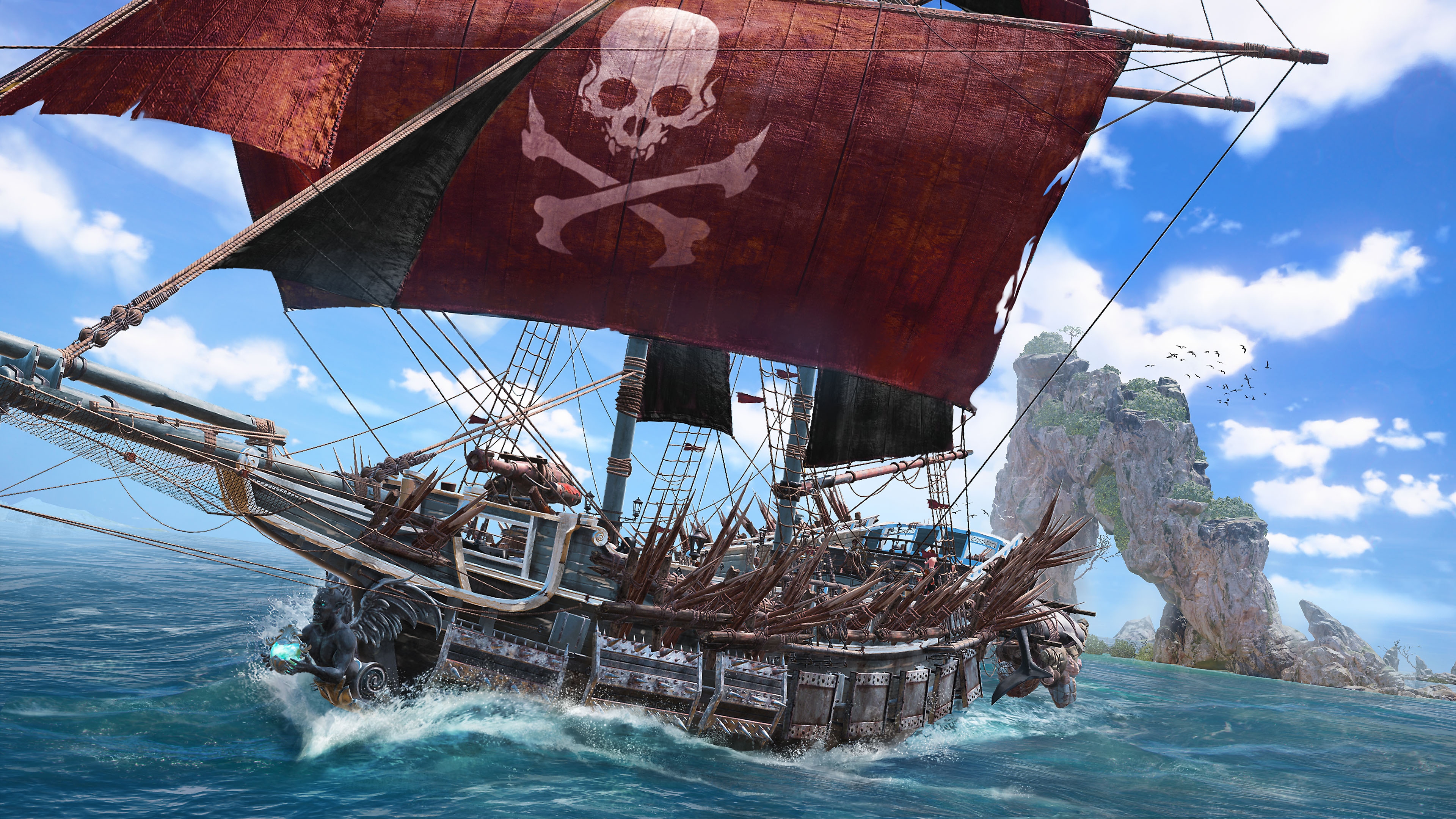 Skull & Bones – snímek ze hry zobrazující pirátskou loď s lebkou a zkříženými hnáty na červené hlavní plachtě